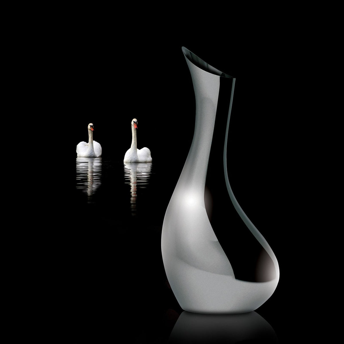 VAGNBYS Swan Carafe with two white swans on dark water behind it